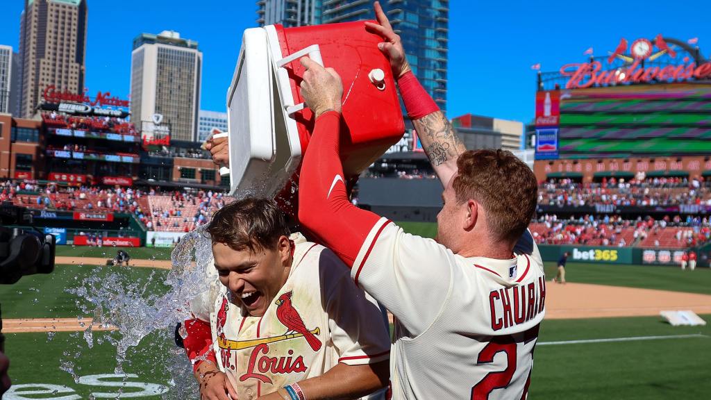 Cardinals player is doused with a water cooler by a teammate on the field after a walk-off win at Busch Stadium.